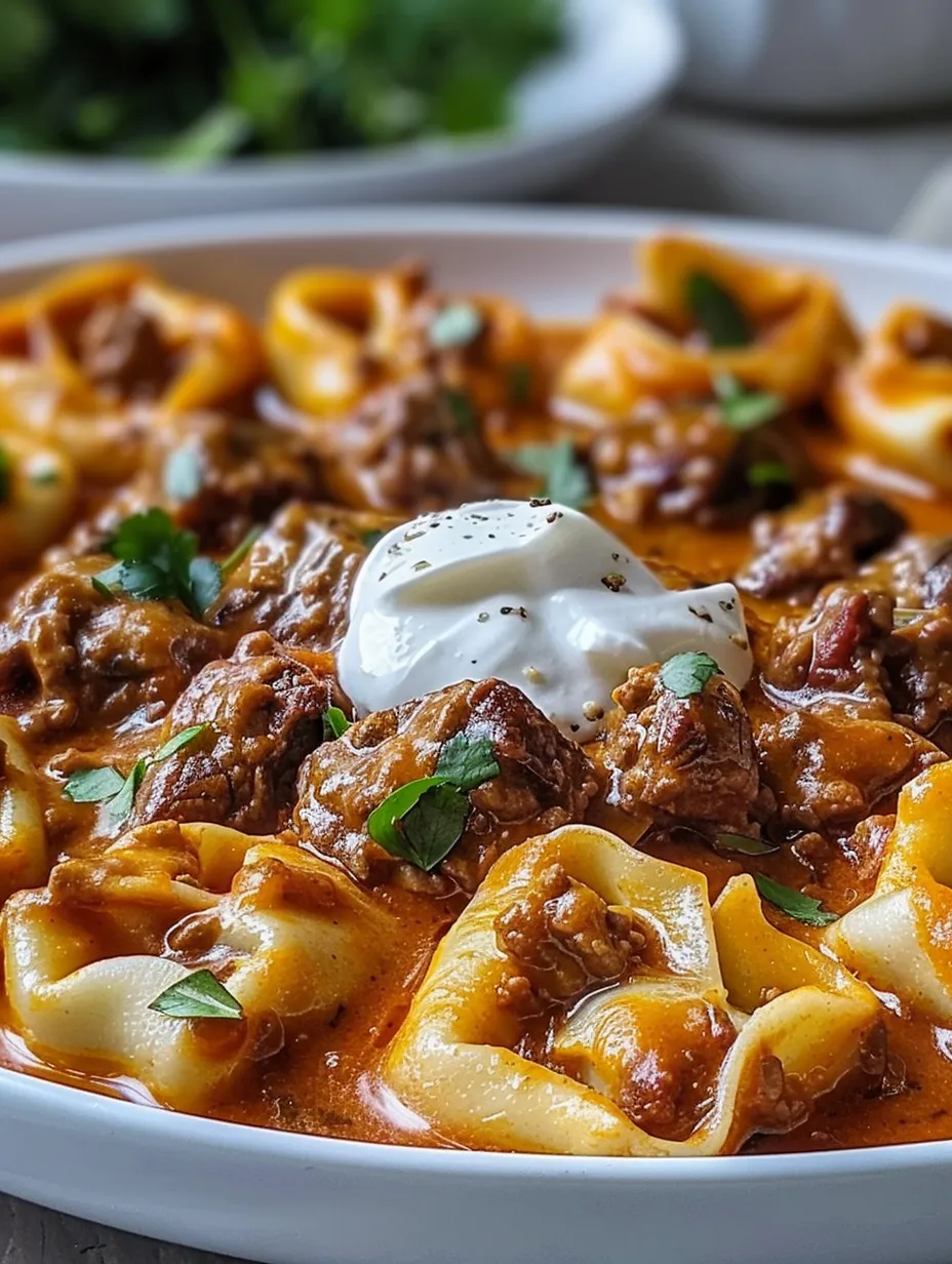 Eine Nahaufnahme von leckeren käsigen Rinder-Enchilada-Tortellini.
